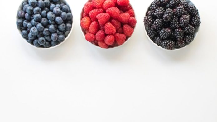 black and red berries on white surface